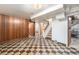 Spacious basement area with checkerboard flooring and wood paneling, offering versatile potential at 7172 Kalamath St, Denver, CO 80221