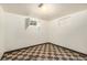 View of a basement area with a checkered floor and painted white walls and window at 7172 Kalamath St, Denver, CO 80221