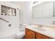 A bathroom with a combined shower and tub, bright tiles, and a classic wood vanity for a comforting feel at 7172 Kalamath St, Denver, CO 80221