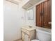 Bright bathroom with a vanity sink and built-in wooden cabinet at 7172 Kalamath St, Denver, CO 80221