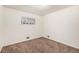 A clean bedroom, featuring neutral walls, plush carpeting, and a sunlit window for a comfortable space at 7172 Kalamath St, Denver, CO 80221