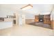 Open-concept space with a stone fireplace, built-in shelving, and seamless access to the kitchen at 7172 Kalamath St, Denver, CO 80221