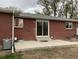 Brick house featuring a patio and sliding glass door leading to a private backyard at 1152 S Eaton St, Lakewood, CO 80232
