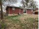 Brick house featuring a patio and sliding glass door leading to a private backyard at 1152 S Eaton St, Lakewood, CO 80232