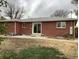 Brick house featuring a patio and sliding glass door leading to a private backyard at 1152 S Eaton St, Lakewood, CO 80232