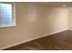 Finished basement area with a wood grain floor and a window with bars at 1152 S Eaton St, Lakewood, CO 80232