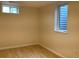 Cozy basement bedroom with a window and stylish wood-look flooring at 1152 S Eaton St, Lakewood, CO 80232