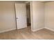Basement bedroom with wood-look flooring and an open doorway at 1152 S Eaton St, Lakewood, CO 80232