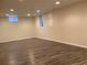 Spacious basement with wood-look flooring, recessed lights, and a window at 1152 S Eaton St, Lakewood, CO 80232