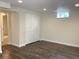 Finished basement area with wood grain flooring and bi-fold closet at 1152 S Eaton St, Lakewood, CO 80232