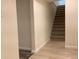 View of the basement stairs, from the basement, with wood-look flooring at 1152 S Eaton St, Lakewood, CO 80232