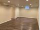 Unfinished basement with modern wood-look floors and recessed lighting at 1152 S Eaton St, Lakewood, CO 80232