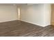 Finished basement area with wood grain flooring, white trim, and neutral walls at 1152 S Eaton St, Lakewood, CO 80232