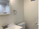 Bathroom with a white vanity, toilet, and a mirror reflecting the subway tile shower at 1152 S Eaton St, Lakewood, CO 80232
