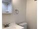 Bathroom with a white sink, toilet, mirror, and subway tile shower at 1152 S Eaton St, Lakewood, CO 80232