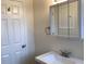 Bathroom sink with vanity, updated faucet, lighting and towel rack, plus a door at 1152 S Eaton St, Lakewood, CO 80232