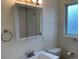 Bathroom featuring a mirrored medicine cabinet, sink, toilet and towel rack at 1152 S Eaton St, Lakewood, CO 80232