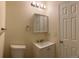 A bathroom with a white sink, mirror, and toilet with a white door at 1152 S Eaton St, Lakewood, CO 80232