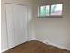 Bedroom featuring hardwood floors, a large closet, and a window offering natural light at 1152 S Eaton St, Lakewood, CO 80232