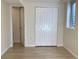 Basement bedroom features bi-fold closet, door to the hall, and wood grain flooring at 1152 S Eaton St, Lakewood, CO 80232