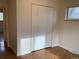 Cozy bedroom with wood floors and closet, with view out the window to a tree at 1152 S Eaton St, Lakewood, CO 80232