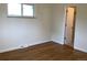 Bright bedroom with hardwood floors and ensuite bathroom at 1152 S Eaton St, Lakewood, CO 80232