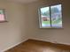 Bright bedroom with hardwood floors and natural light from two windows overlooking the street at 1152 S Eaton St, Lakewood, CO 80232