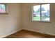 Bright bedroom featuring wood floors and two large windows offering neighborhood views at 1152 S Eaton St, Lakewood, CO 80232