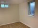 Basement bedroom with wood grain flooring and a window with bars at 1152 S Eaton St, Lakewood, CO 80232