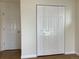 Spacious closet and view of a bedroom door frame with hardwood floors and neutral wall color at 1152 S Eaton St, Lakewood, CO 80232