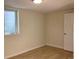 A bright bedroom features a window for natural light and a minimalist aesthetic with light-colored walls and flooring at 1152 S Eaton St, Lakewood, CO 80232