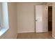 Basement bedroom with wood grain flooring and white painted door at 1152 S Eaton St, Lakewood, CO 80232