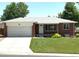 Traditional brick home featuring an attached garage, a well-kept lawn and classic curb appeal at 1152 S Eaton St, Lakewood, CO 80232