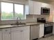A bright kitchen with stainless steel appliances, granite countertops, and white subway tile back splash at 1152 S Eaton St, Lakewood, CO 80232
