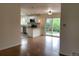Open-concept layout with modern white kitchen flowing into a dining area and hardwood floors at 1152 S Eaton St, Lakewood, CO 80232