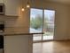 Kitchen with stainless steel appliances and a view to the backyard patio at 1152 S Eaton St, Lakewood, CO 80232