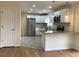A recently renovated kitchen features stainless steel appliances, granite countertops, and updated cabinets at 1152 S Eaton St, Lakewood, CO 80232