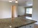 Bright kitchen features a granite island and view to an adjacent room at 1152 S Eaton St, Lakewood, CO 80232