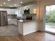 Bright kitchen with white cabinets, stainless steel appliances, and granite countertops at 1152 S Eaton St, Lakewood, CO 80232