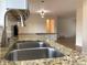 Close-up of kitchen sink featuring granite countertops and stainless steel faucet at 1152 S Eaton St, Lakewood, CO 80232