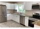 Modern kitchen featuring white cabinets, stainless steel appliances, and granite countertops at 1152 S Eaton St, Lakewood, CO 80232