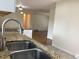 Close up on kitchen sink and counters with hardwood floor in the background at 1152 S Eaton St, Lakewood, CO 80232