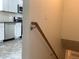 Kitchen view showcasing stainless steel appliances and white cabinets next to staircase at 1152 S Eaton St, Lakewood, CO 80232