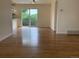 Open floor plan with hardwood floors and sliding glass doors leading to the backyard at 1152 S Eaton St, Lakewood, CO 80232