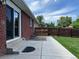 Concrete patio area outside the brick home, perfect for outdoor lounging and entertaining guests at 1152 S Eaton St, Lakewood, CO 80232