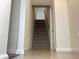 Carpeted staircase leading to the upper level of a home with neutral colored walls at 1152 S Eaton St, Lakewood, CO 80232