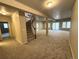 Spacious basement with neutral carpet, access to the upper floors via the staircase, and large windows to the backyard at 22148 Red Hawk Ln, Golden, CO 80401