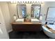 Modern bathroom featuring a floating double vanity and a soaking tub and shower combo at 22148 Red Hawk Ln, Golden, CO 80401
