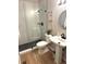 Modern bathroom with glass shower, updated fixtures, and stylish pedestal sink at 22148 Red Hawk Ln, Golden, CO 80401