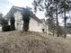 Exterior view of a stucco home with a terracotta roof, landscaped yard, and mature trees in the background at 22148 Red Hawk Ln, Golden, CO 80401